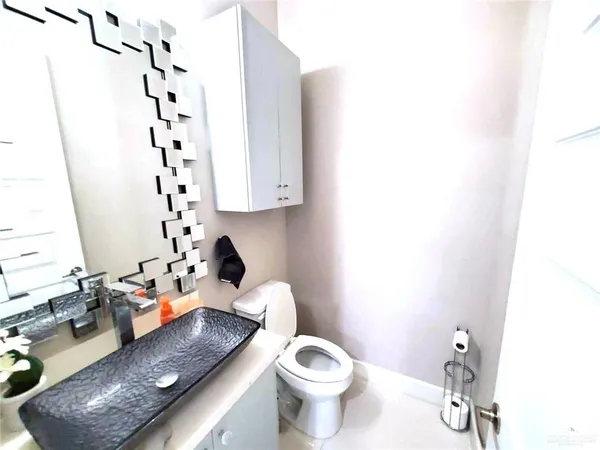 a white toilet sitting next to a bathroom sink