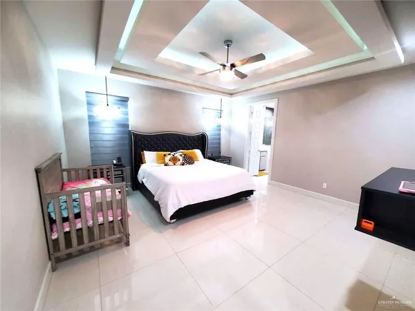 a bedroom with a bed and a chandelier