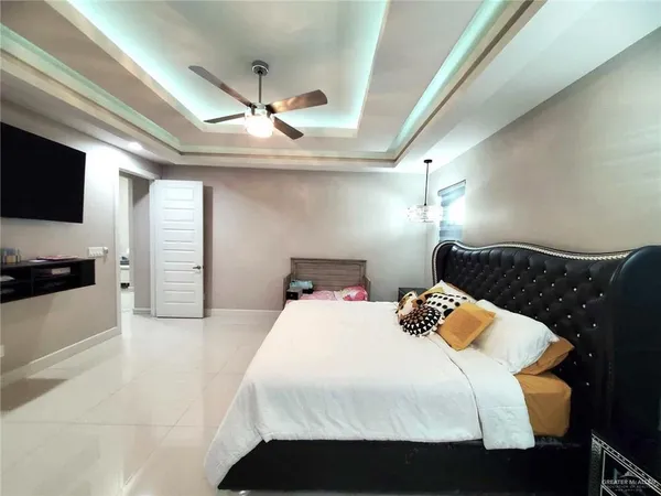 a bedroom with a bed and a television