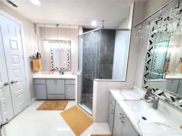 a spacious bathroom with a sink double vanity and a mirror