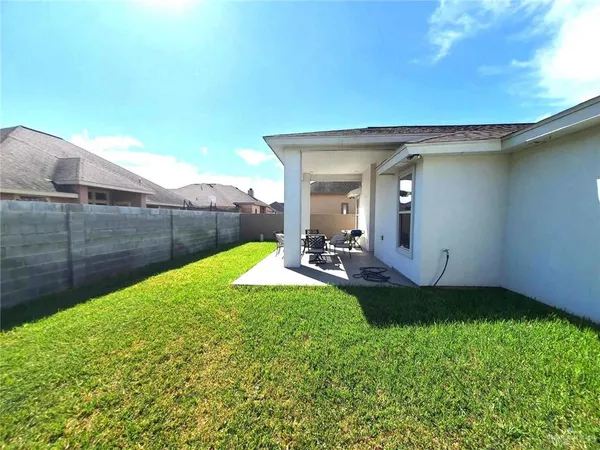 a view of a backyard with table and chairs