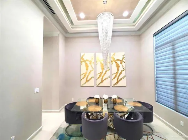 a dining room with furniture and a chandelier