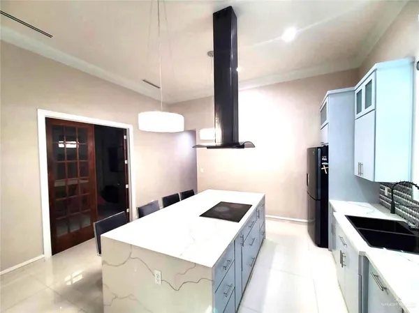 a kitchen with a sink a stove and a refrigerator