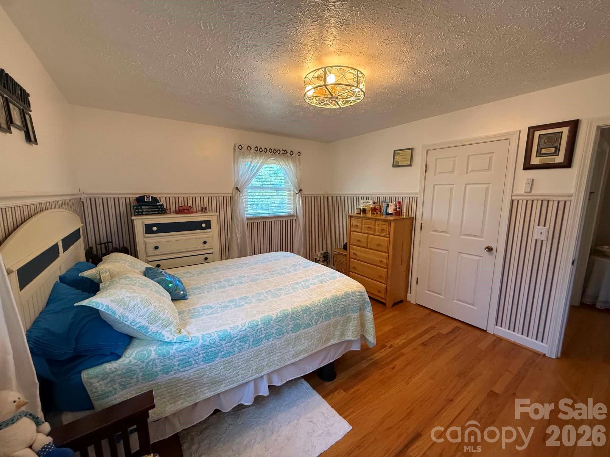 2121 Union Grove Road Lenoir, NC 28645 - Photo 21 of 38 a bedroom with a bed and wooden floor