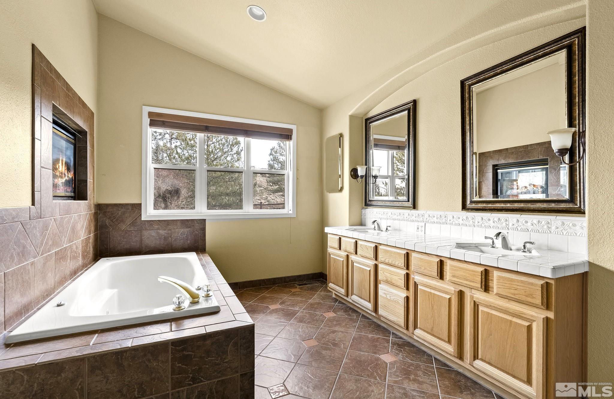 3420 Cheechako Drive Reno, NV 89519 - Photo 14 of 30 a bathroom with a tub sink and mirror