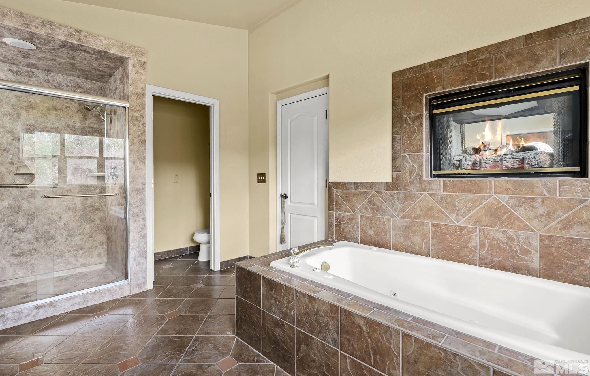 3420 Cheechako Drive Reno, NV 89519 - Photo 15 of 30 a bathroom with a tub a sink and glass door