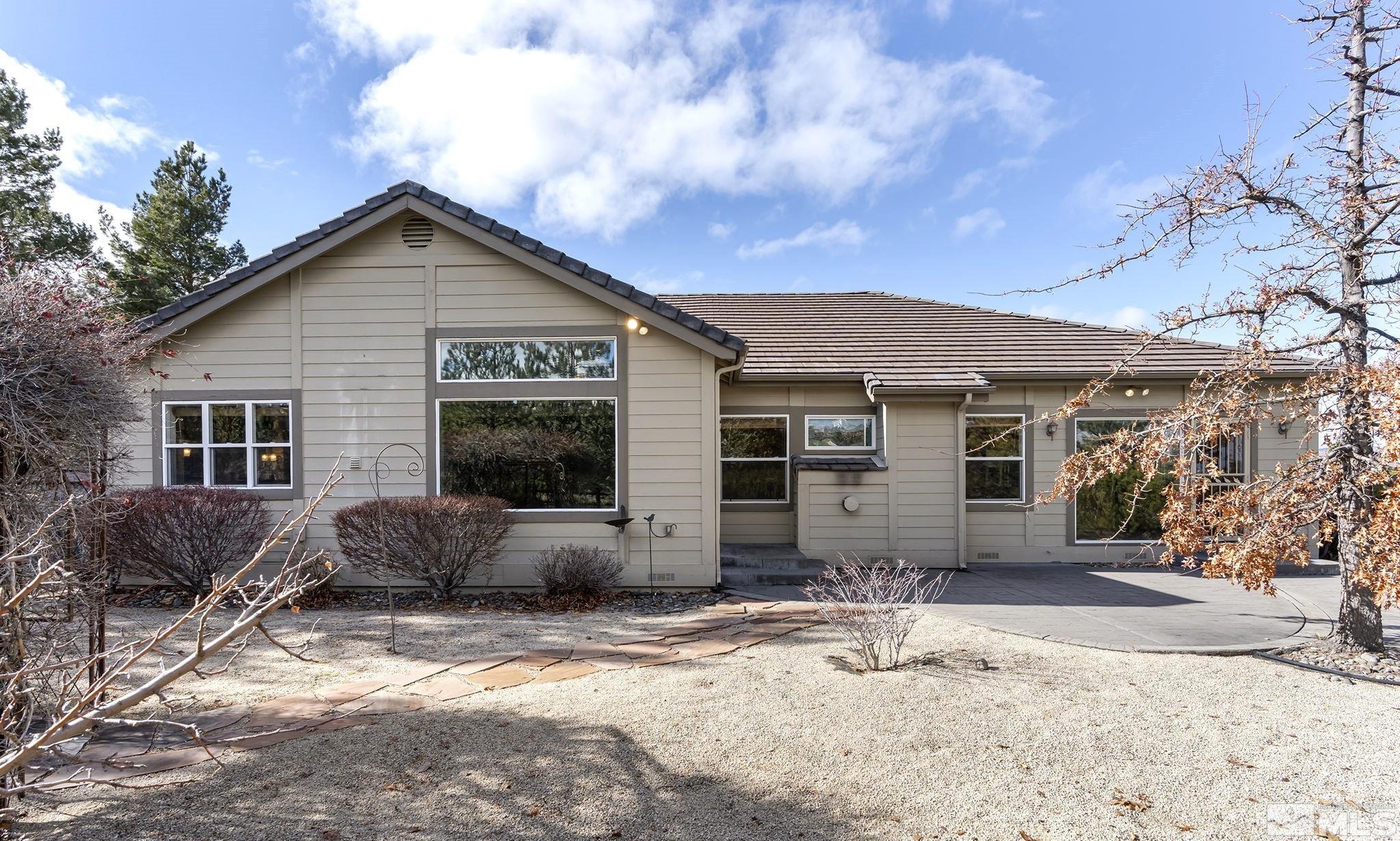 3420 Cheechako Drive Reno, NV 89519 - Photo 27 of 30 a front view of a house with a yard and garage