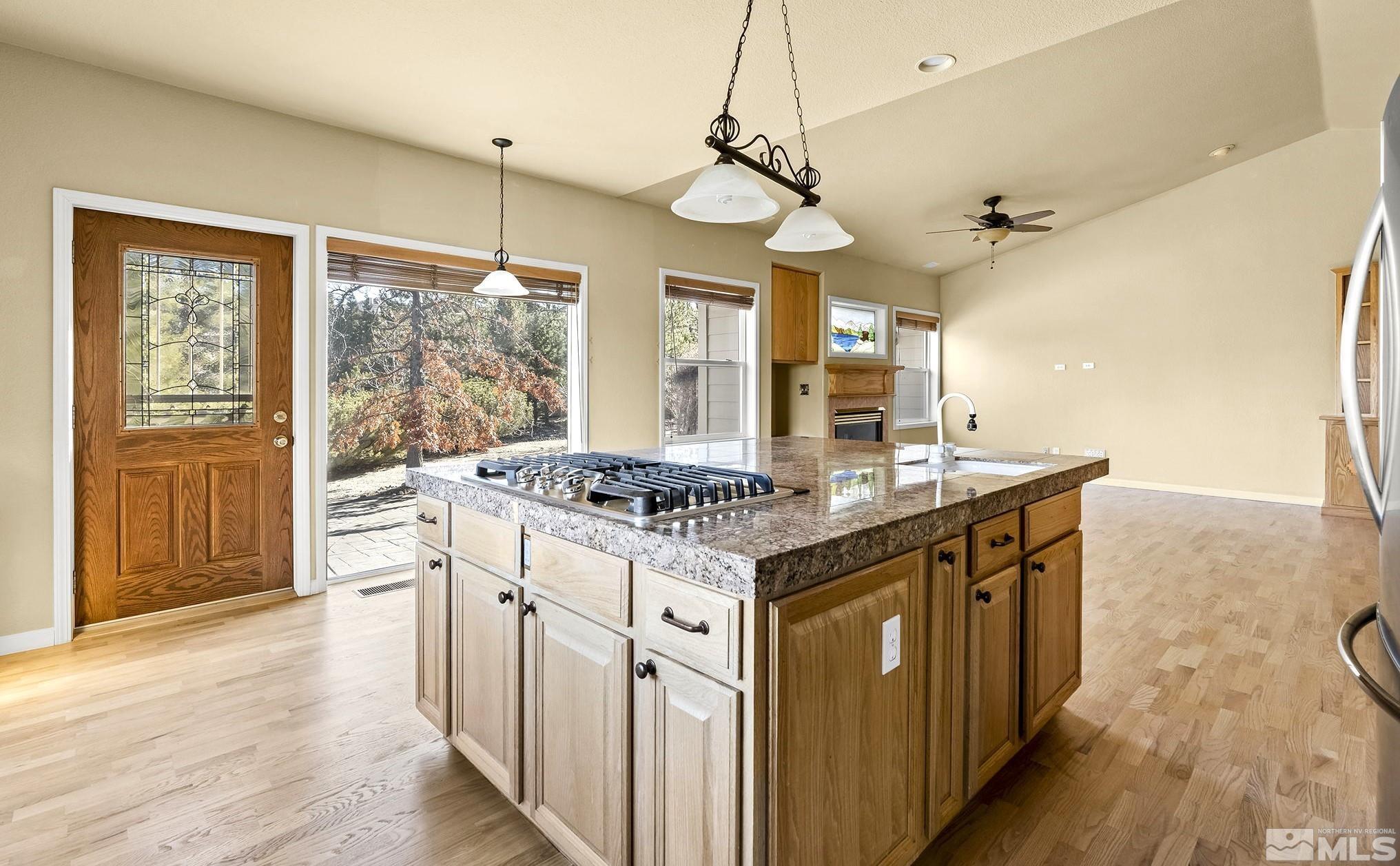3420 Cheechako Drive Reno, NV 89519 - Photo 3 of 30 a kitchen with a stove and wooden floor