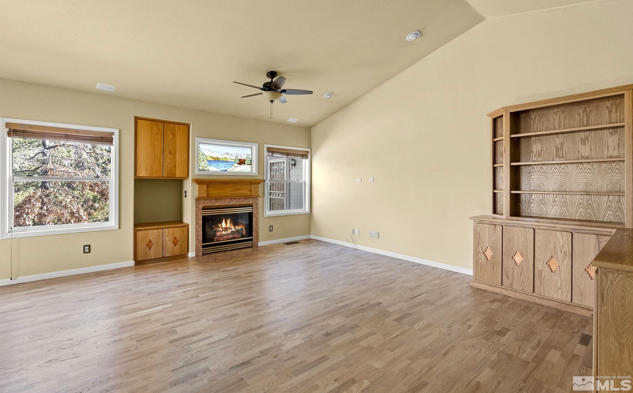 3420 Cheechako Drive Reno, NV 89519 - Photo 7 of 30 a view of a livingroom with a fireplace and window