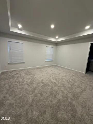 a spacious bathroom with a double vanity sink toilet mirror and shower