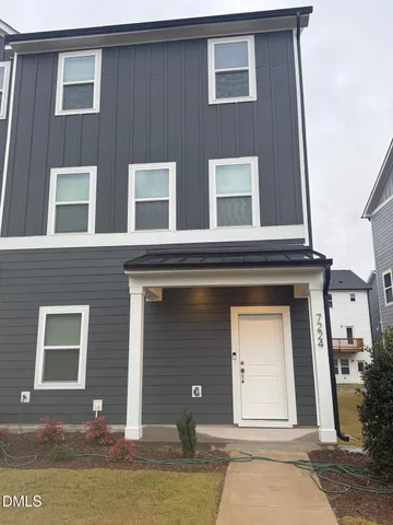 a front view of a house with lake