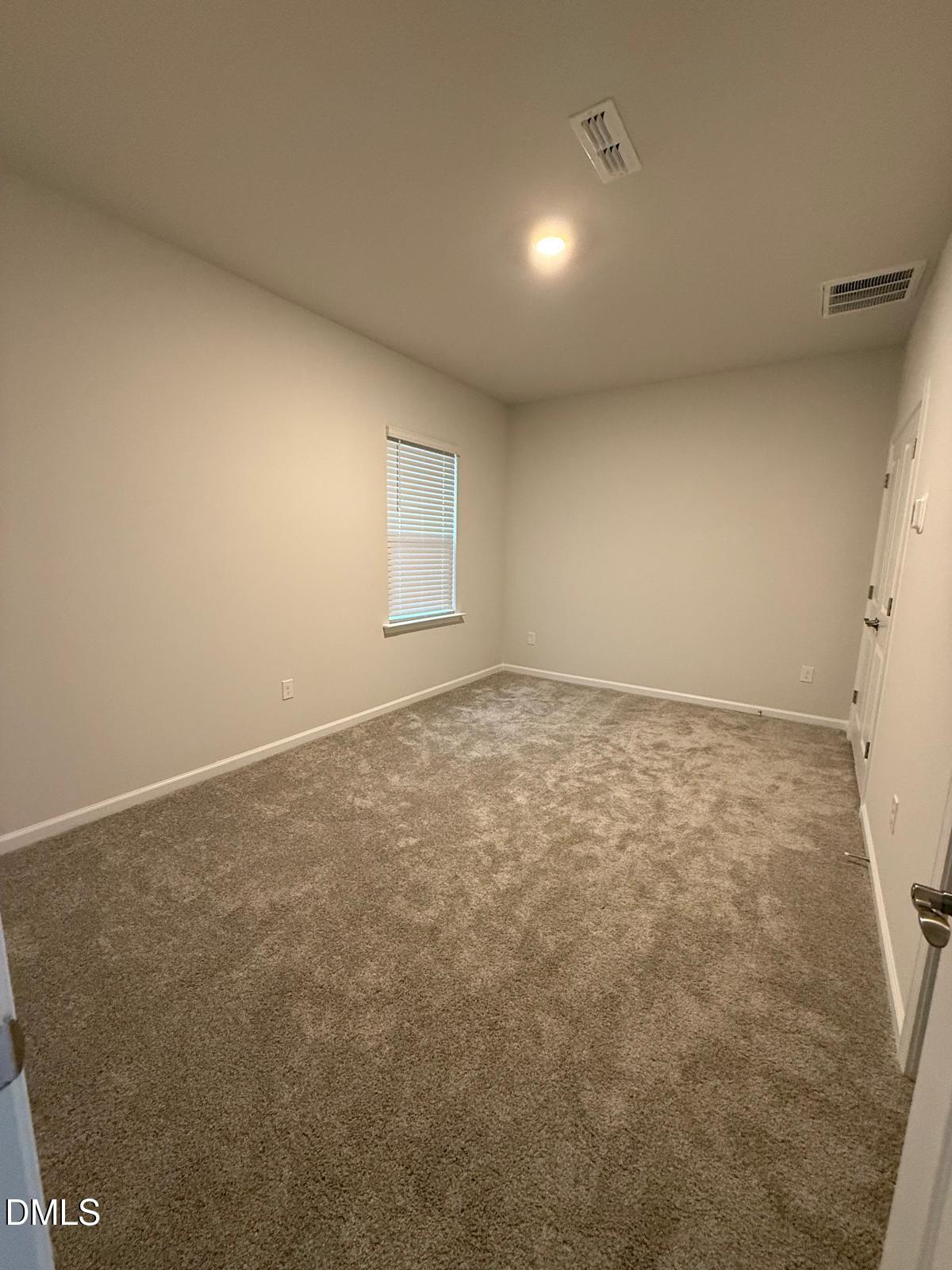 7224 Morris Acres Road Apex, NC 27523 - Photo 8 of 23 an empty room with a natural light