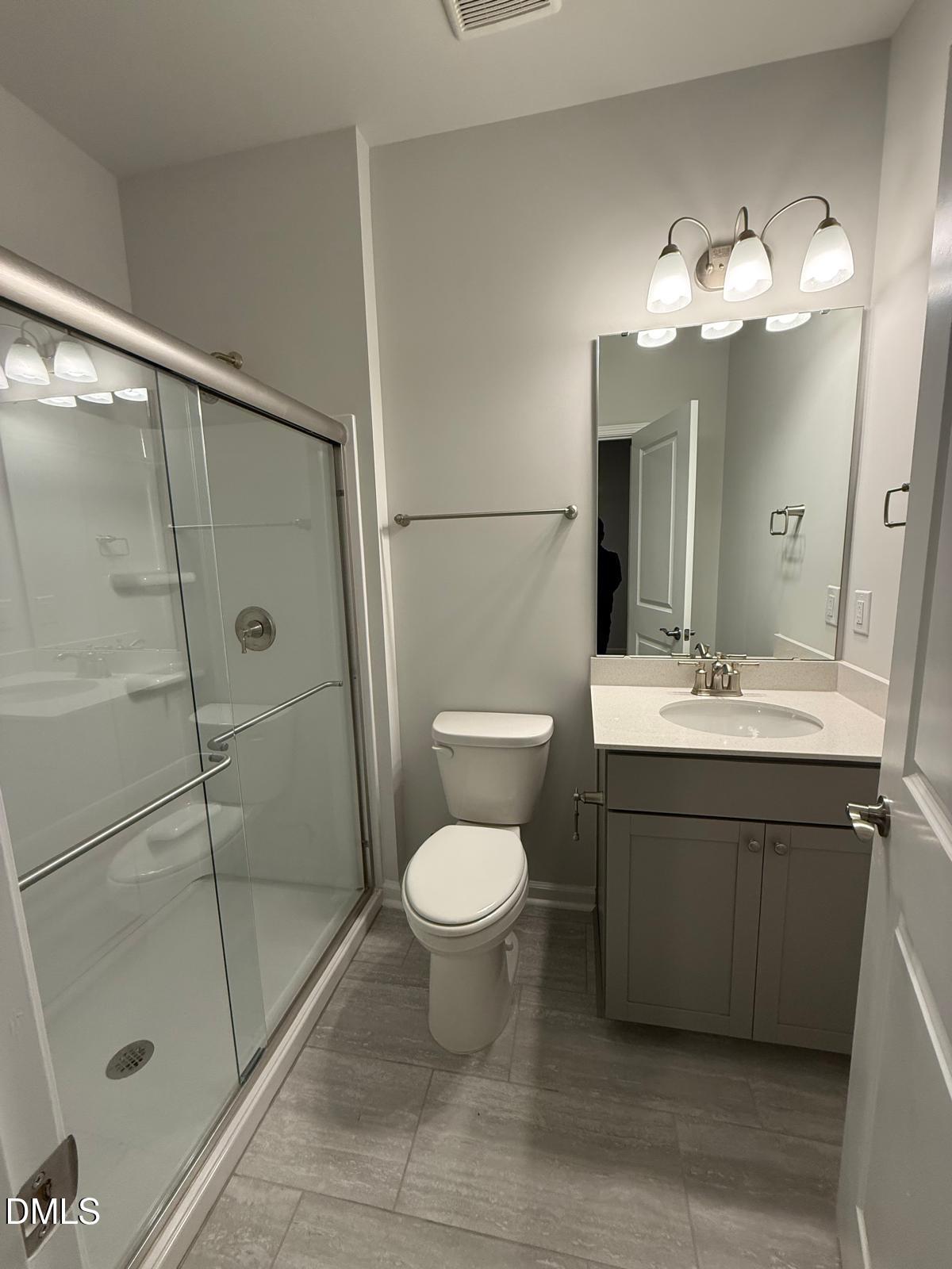 7224 Morris Acres Road Apex, NC 27523 - Photo 9 of 23 a bathroom with a sink toilet and shower