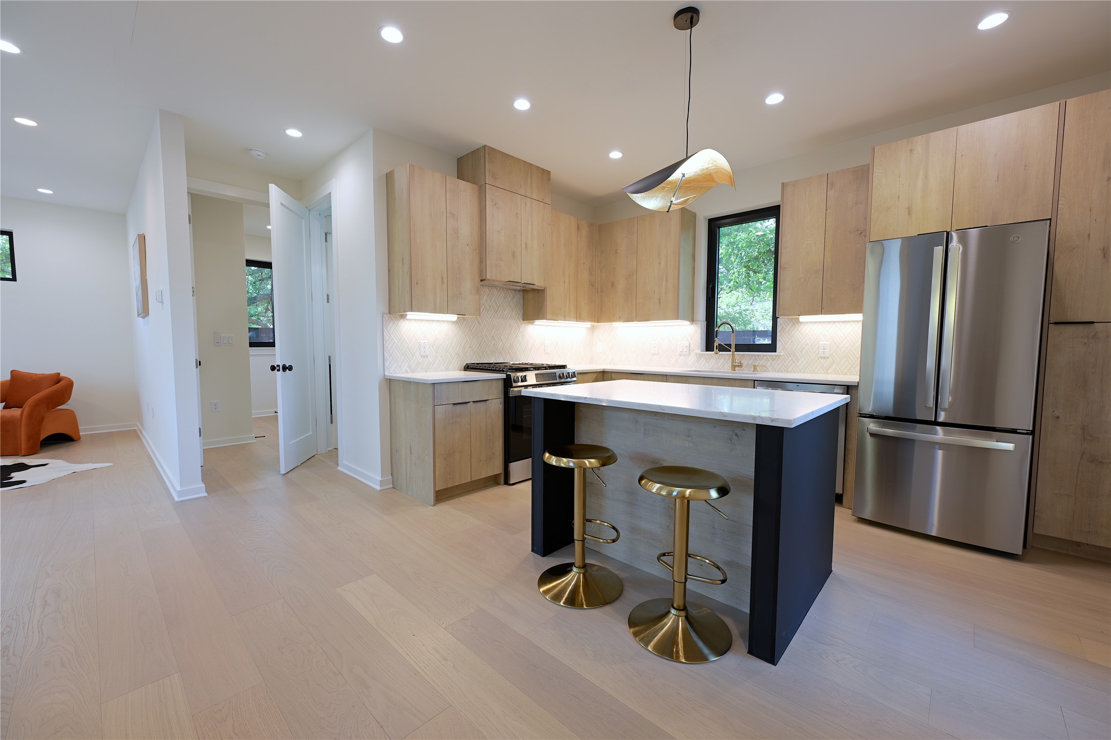 4410 Glomar Avenue, Unit 2 Austin, TX 78721 - Photo 8 of 24 The kitchen features light wood European style cabinetry, stainless steel appliances, a center island with seating, and recessed lighting