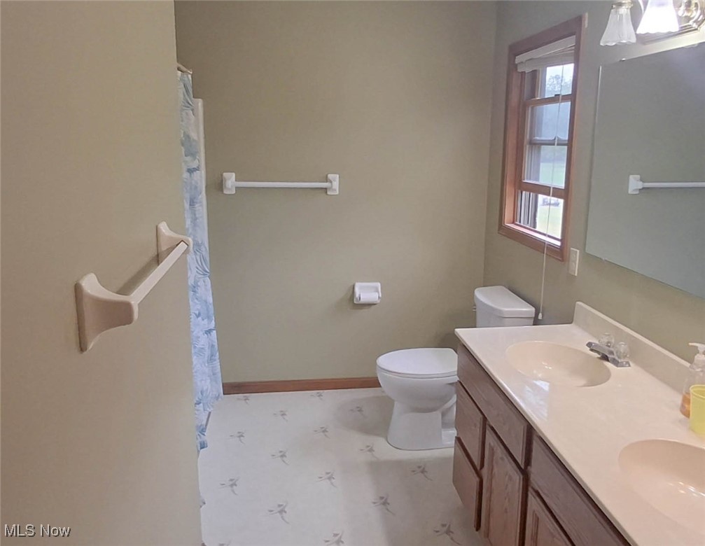 11737 Gladstone Road Warren, OH 44481 - Photo 18 of 41 Full bath with double vanity and a shower with curtain