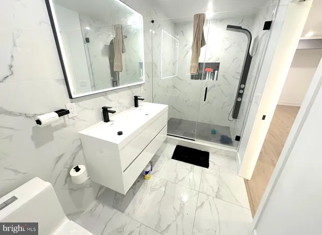 a bathroom with a sink mirror and toilet