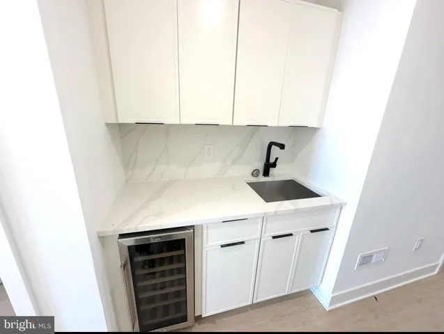 a kitchen with stainless steel appliances granite countertop a refrigerator sink and stove