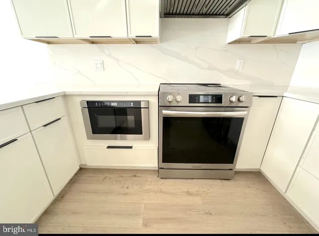 a kitchen with stainless steel appliances a refrigerator sink and stove
