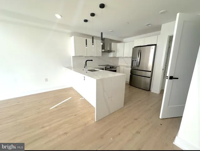 a view of a hallway with wooden floor fireplace and living room