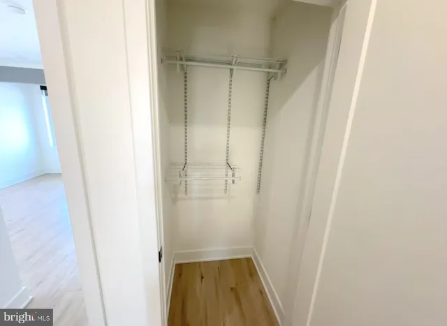 an empty room with wooden floor and a window