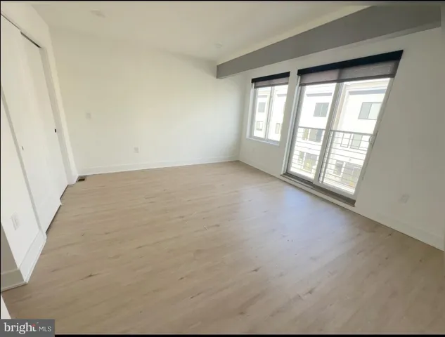a bedroom with a bed table and a potted plant