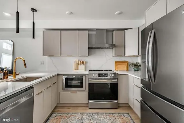 a kitchen with a refrigerator and a stove