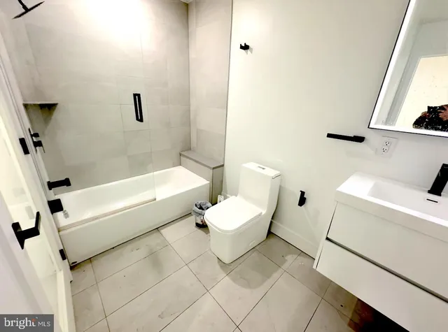 a kitchen with stainless steel appliances a refrigerator stove and wooden floor