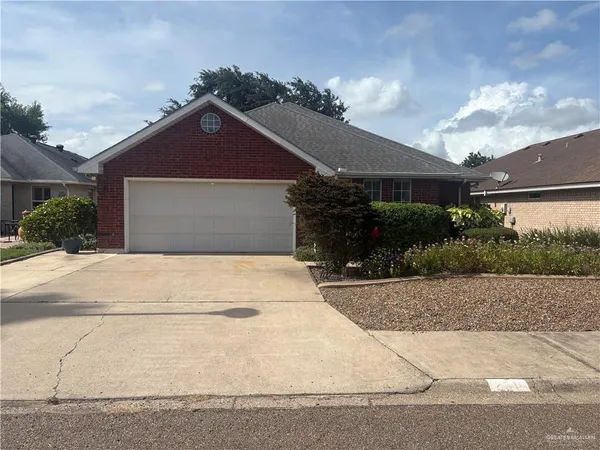 a front view of a house with a yard and a garage