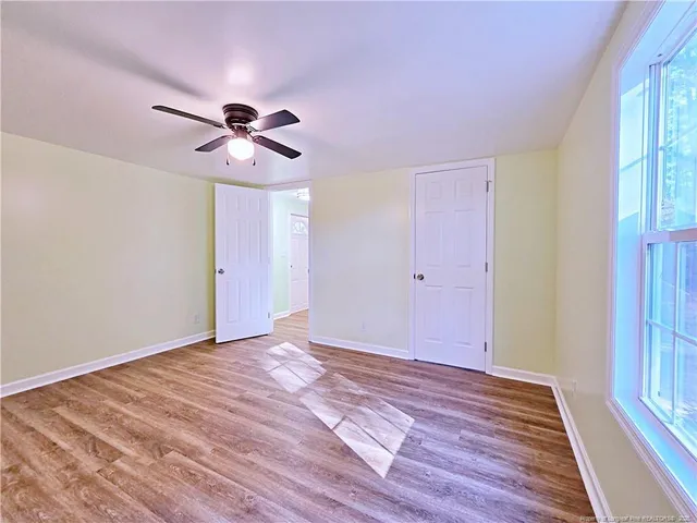 a view of room with hardwood floor and ceiling fan