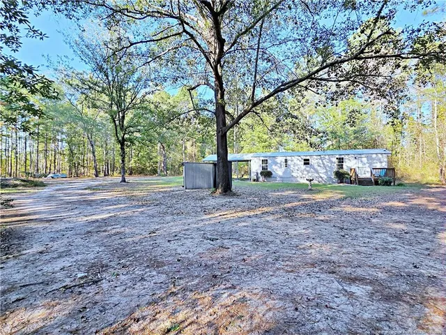a view of outdoor space with garden and trees