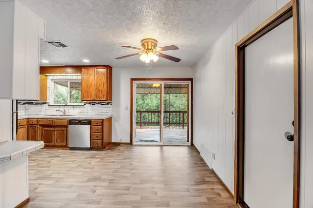 a view of a kitchen with a sink and a large window
