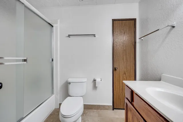 a white toilet sitting next to a bathroom sink