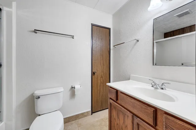 a bathroom with a sink toilet and vanity
