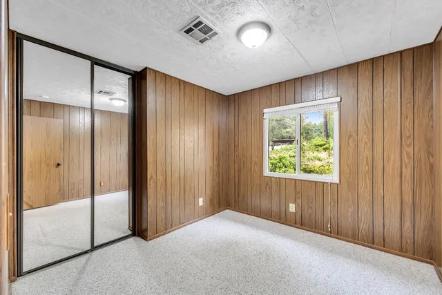 an empty room with windows and closet