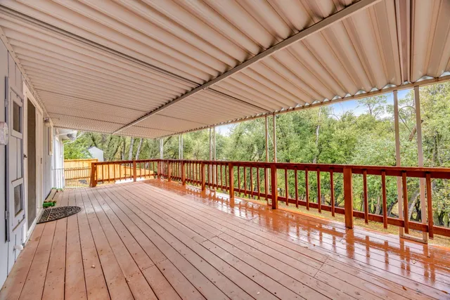 a view of porch with wooden floor