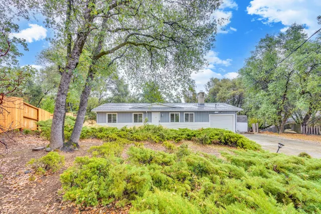 a backyard of a house with yard and outdoor seating