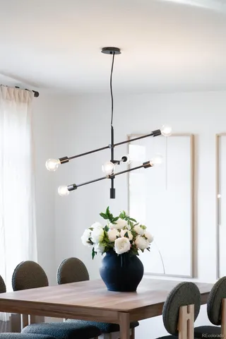 a kitchen with a center island wooden floor and stainless steel appliances