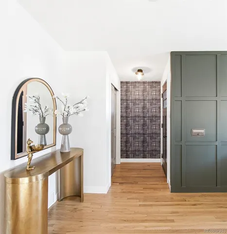 a living room with furniture a wooden floor and a large window