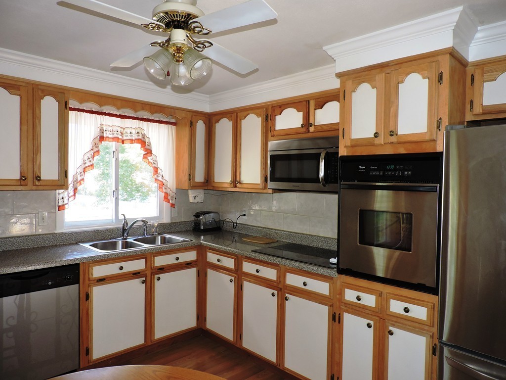 22 Palo Alto Road Springfield, MA 01128 - Photo 11 of 28 a kitchen with stainless steel appliances granite countertop a sink a stove and cabinets