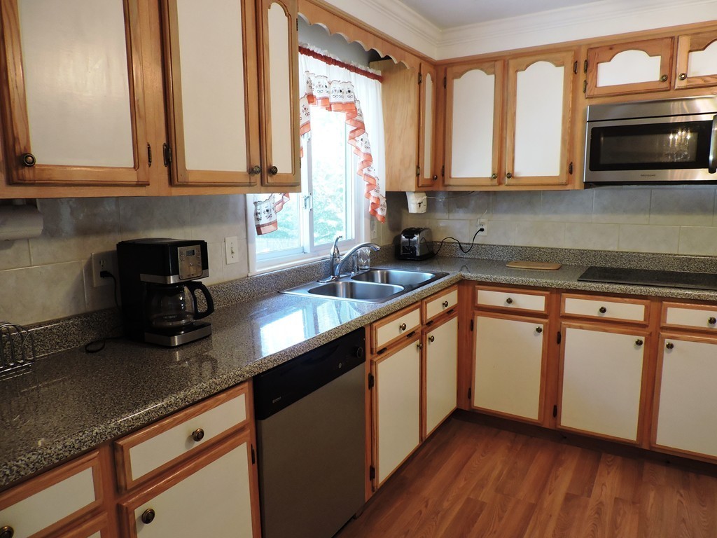 22 Palo Alto Road Springfield, MA 01128 - Photo 9 of 28 a kitchen with stainless steel appliances granite countertop a sink a stove and cabinets