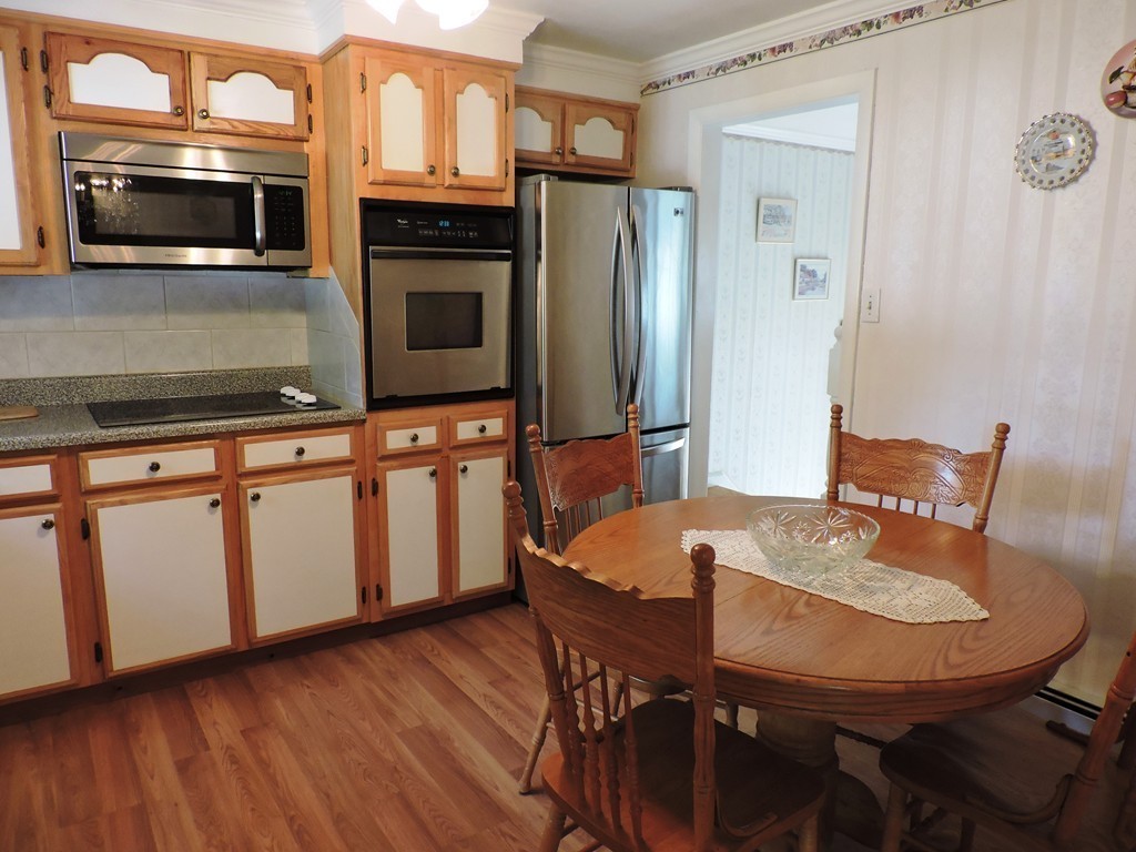 22 Palo Alto Road Springfield, MA 01128 - Photo 10 of 28 a kitchen with stainless steel appliances a microwave a stove and white cabinets