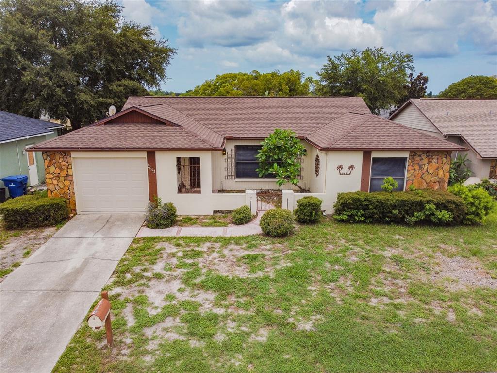 9433 Barnstead Lane Port Richey, FL 34668 - Photo 1 of 1 a front view of a house with a yard