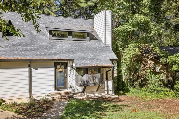 a view of a house with backyard and sitting area