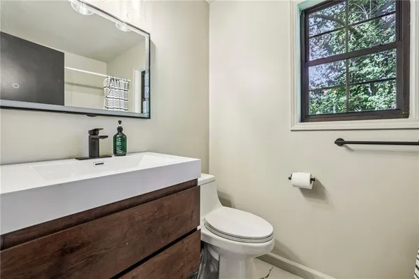 a bathroom with a sink a mirror and a toilet