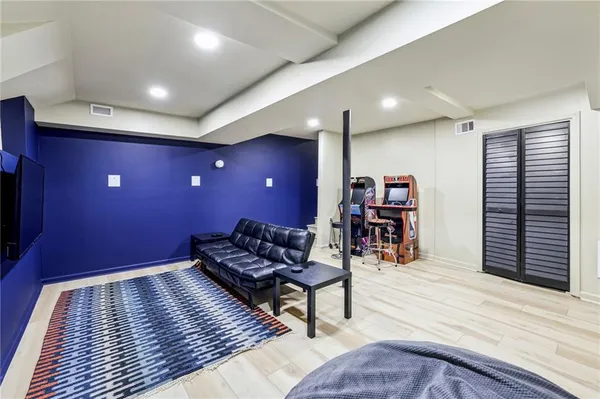 a living room with furniture and wooden floor
