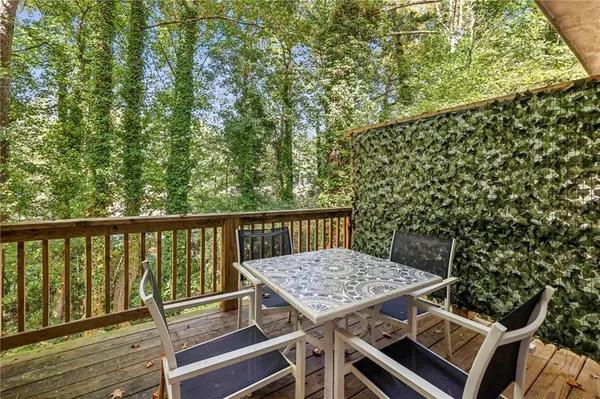 a view of balcony with wooden floor and seating space
