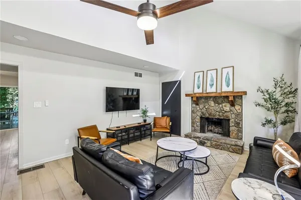 a living room with furniture and a fireplace