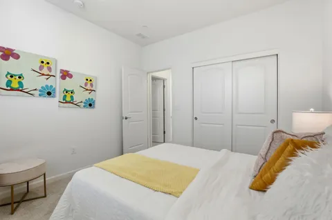 a bedroom with a bed and a window