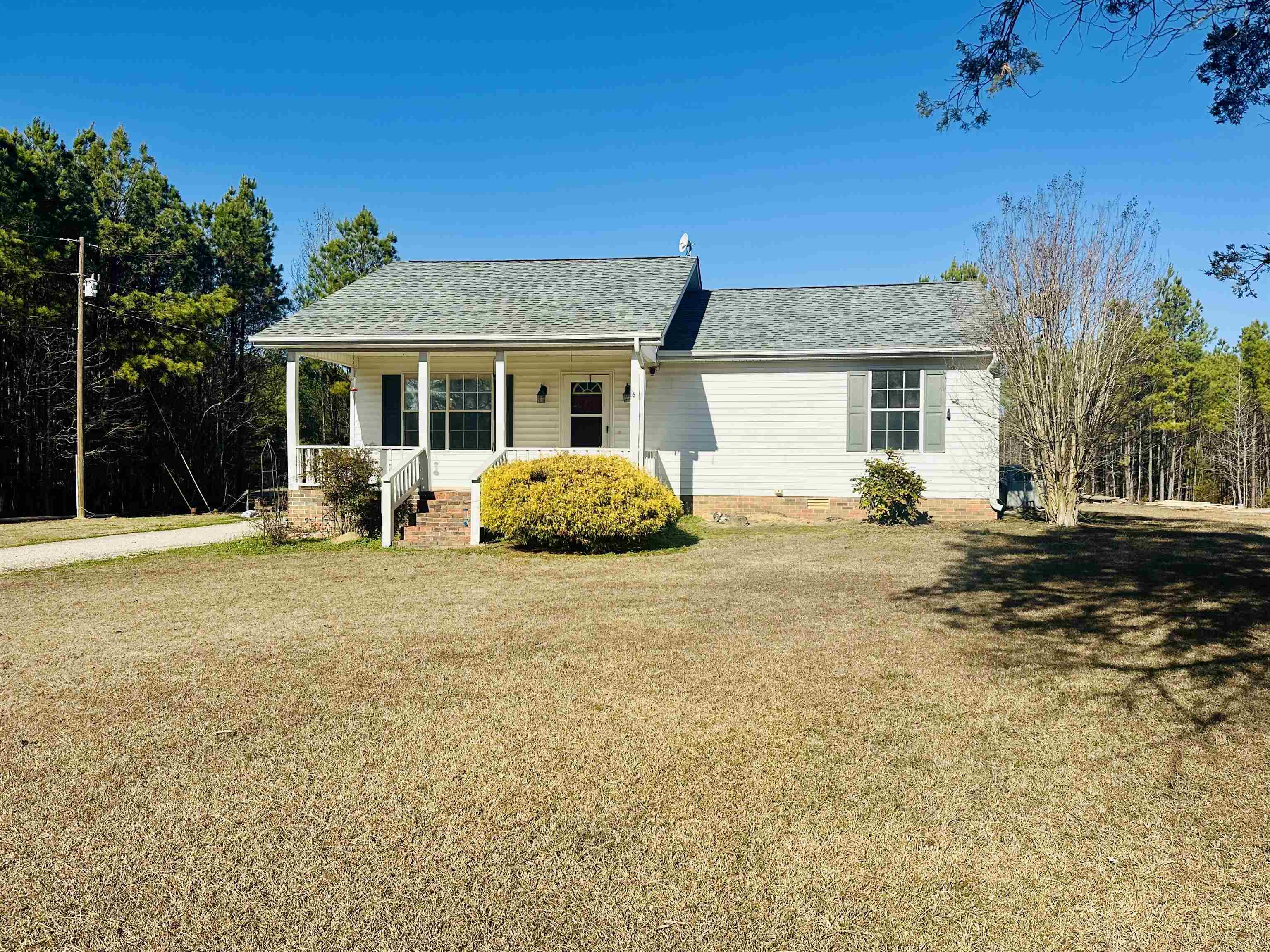 3566 Highway 142 Selmer, TN 38375 - Photo 1 of 20 View of front of house with covered porch, roof with shingles, and a front lawn