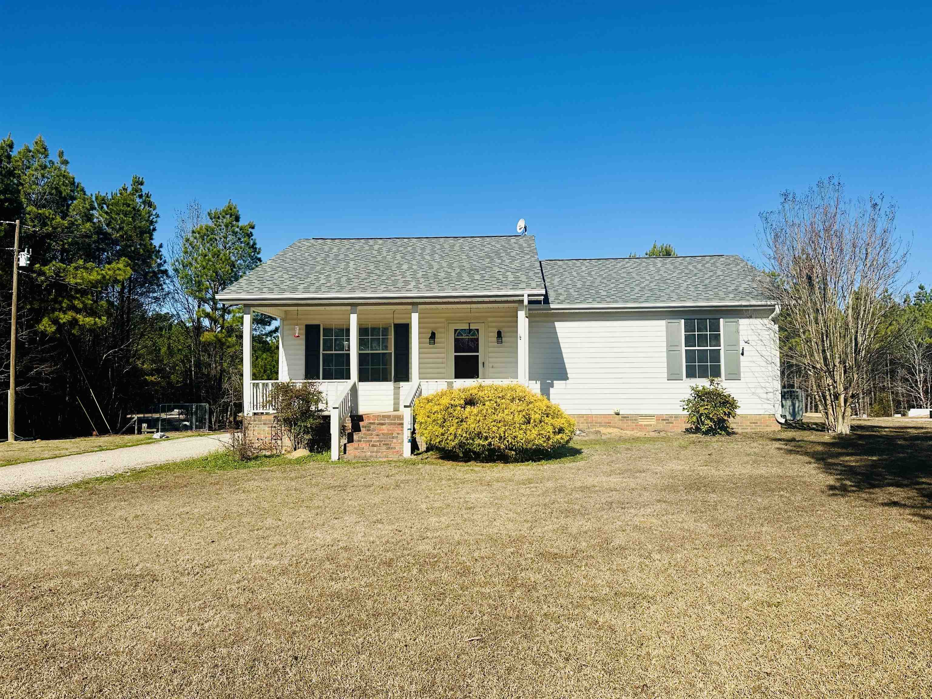 3566 Highway 142 Selmer, TN 38375 - Photo 16 of 20 View of front of home featuring covered porch, a front lawn, and a shingled roof
